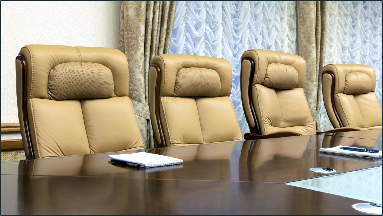 Executive boardroom with leather chairs and conference table